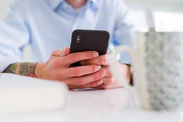 Close up of business man working using smartphone