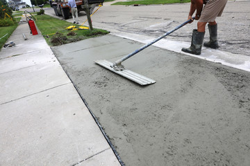 concrete work is being performed at a home in a urban neighborhood