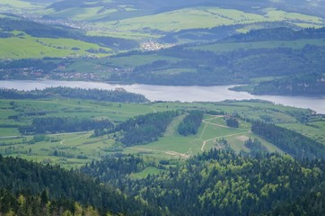 Beautiful mountain spring landscape. View of the Czorsztyn Lake and green valleys and hills.