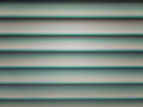 Beautiful facade detail with bright green turquoise shutters. Wooden jalousie texture, background, wallpaper. Template idea, blindes backdrop