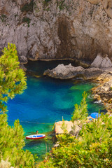  Rocky beach between Faraglioni cliffs of Capri, Italy.