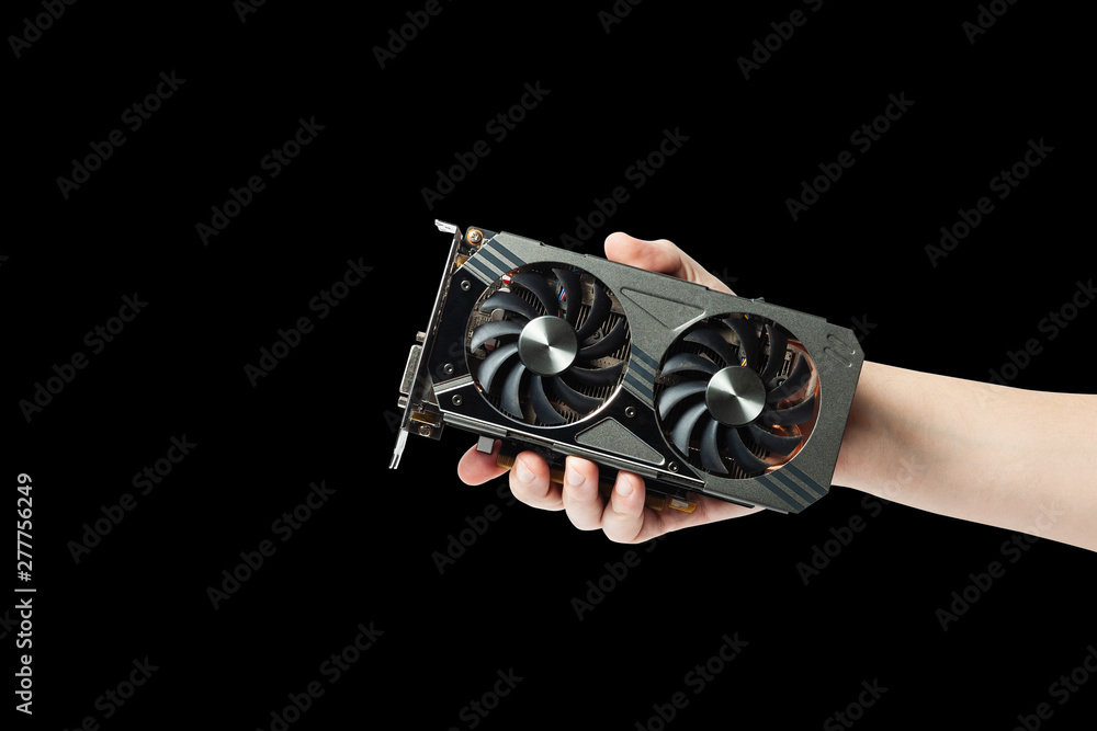 Poster man hold graphic gpu video adapter isolated on a black background. hardware for processing with comp