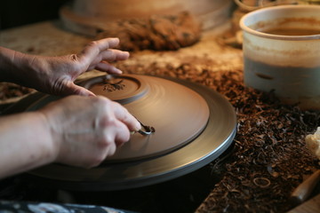 Lady working at clay dish pottery workshop