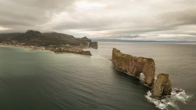 Aerial panoramic view of a beautiful modern town on the Atlantic Ocean Coast during a cloudy sunset. Taken in Perce, Quebec, Canada. Still Image Continuous Animation