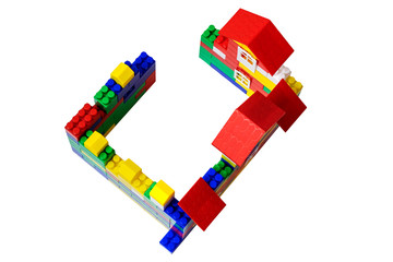 Multi-storey multi-colored house of toy plastic bricks. Top view