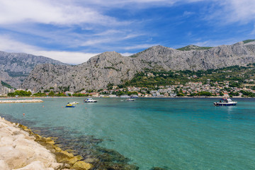 Fototapeta na wymiar The picturesque coastline of the Adriatic sea in the town of Omis, Makarska Riviera, Dalmatia region, Croatia