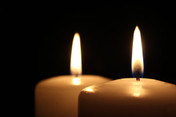 Two large white candles with small copy space at the left