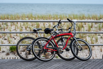 Fototapeta na wymiar Two bicycles parked on Atlantic city beach boardwalk.