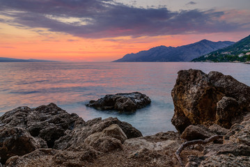Fototapeta premium Beautiful sunset on the sea. The Adriatic sea during sunset, the village of Brela, Makarska Riviera, Croatia