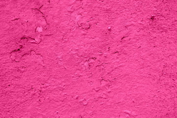 Dirty pink stucco wall with irregularities