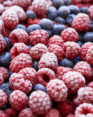 Background of frozen berries. Top view of raspberries and blueberries.