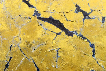 A dirty black and gold surface, an abstraction with jagged edges.