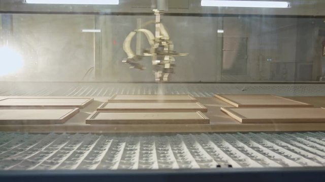 Automated wood painting robot in a furniture production facility