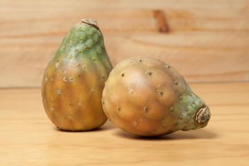 Prickly pear cactus fruits - Opuntia ficus indica; photo on wooden background