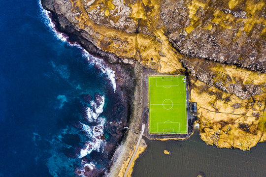 Aerial view of soccer field by coastline