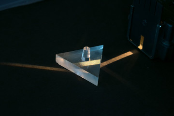 Demonstration of breaking of light in a prism. Science experiment.