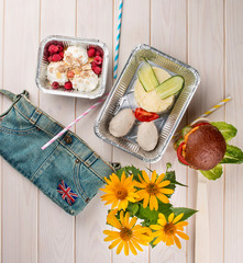 Breakfast diet dishes in containers, on a light wooden background. Takeaway. Diet and healthy food.