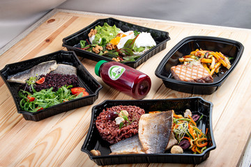 Set of diet dishes in containers on a light wooden background. Takeaway. Diet and healthy food.