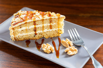A slice of cream and walnuts sponge pie.