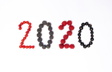 happy new year 2020 made of berries on the white background.