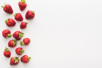 top view of sweet and red strawberries on white background