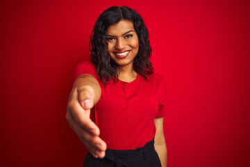 Beautiful transsexual transgender woman wearing t-shirt over isolated red background smiling...