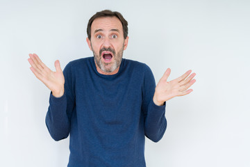 Elegant senior man over isolated background clueless and confused expression with arms and hands...