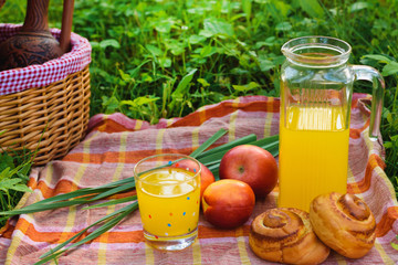 Picnic basket with wine fruit and other products on a natural wooden background. Summer rest . Camping. Picnic in nature.
