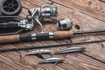 Fishing tackle for catching predatory fish. Wobblers, spinning, reel, fishing line on the wooden...