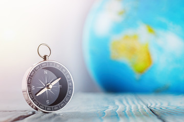 Travel compass and earth globus on wooden background. Journey, adventure lifestyle.Road to...
