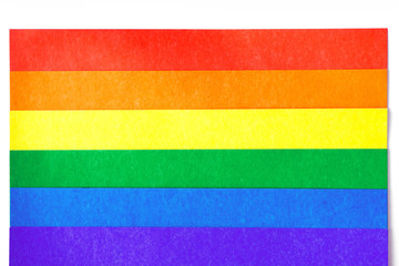 colored sheets of cardboard in the form of the LGBT flag on a white background