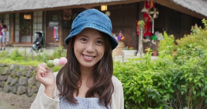 Woman having japanese dango in japanese traditional house