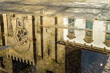 Reflexion of the catholic church in puddle