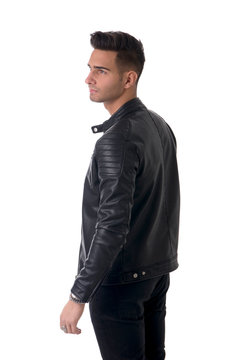 Young handsome man standing in studio shot, isolated on white, wearing black leather jacket and black jeans