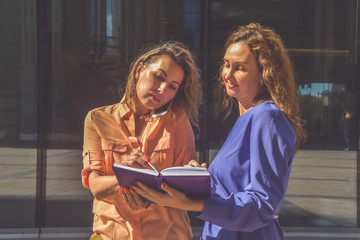 outside business girl and office with phone notepad and pen