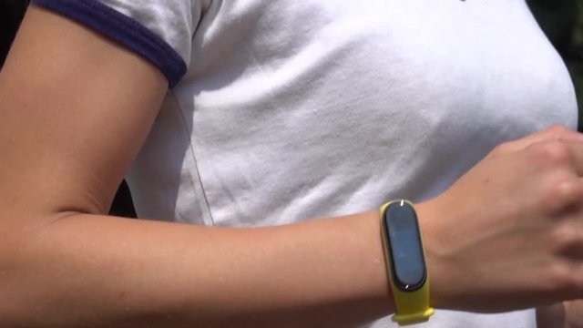 Woman Doing Jogging with a Smart Band, Slow Motion, Close Up