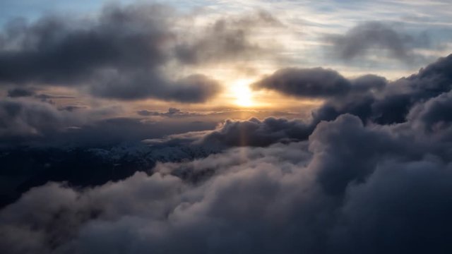 Beautiful and striking aerial view of the puffy clouds during a colorful sunset. Taken near Vancouver, British Columbia, Canada. Still Image Continuous Animation