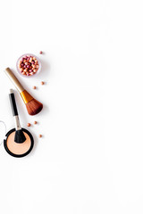 Brushes for make up, blusher and powder on white visagiste work desk background top view copyspace