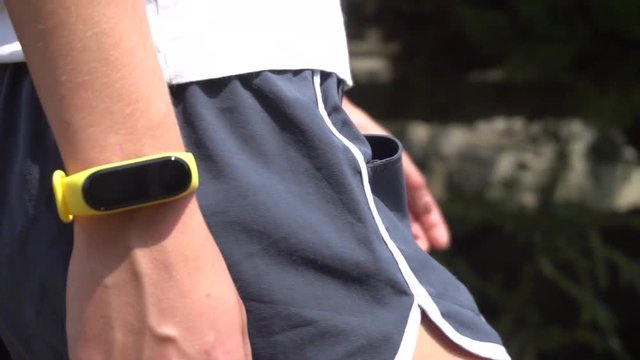 Woman Doing Jogging with a Smart Band, Slow Motion, Close Up