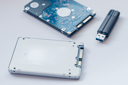 SSD drive, USB Pendrive and 2.5 HDD drive. Solid State Drive vs traditional HDD, isolated. Fast storage device vs slow.