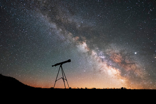 Silhouette Of A Telescope At The Starry Night And Bright Milky Way Galaxy.