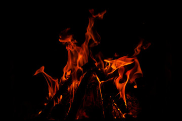 Fundo escuro com chamas de fogo de lareira formando figuras abastratas.