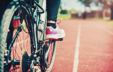 Woman riding a bike, close up photo. Sport and recreation concept