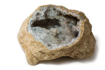 A quartz geode stone placed on the white background. Horizontal studio shot. - obrazy, fototapety, plakaty