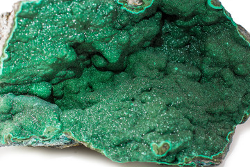 A malachite stone placed on the white background. Horizontal studio shot.