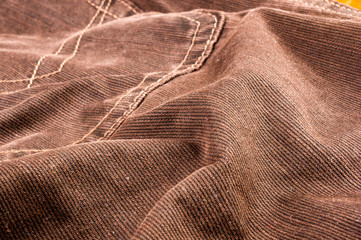 clothing items stonewashed cotton fabric texture with seams, clasps, buttons and rivets, macro