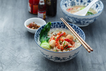 White bee hoon soup with shrimps, scallops and calamari, copy space