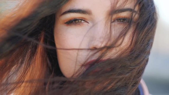 Female beauty. Piercing look. Tranquil serene closeup woman portrait. Focus on brown eyes