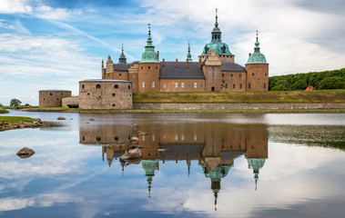 Kalmar Castle on a quiet summer morning with reflection in the calm water in the foreground. - obrazy, fototapety, plakaty