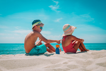 sun protection, cute girl and boy with sun cream at beach